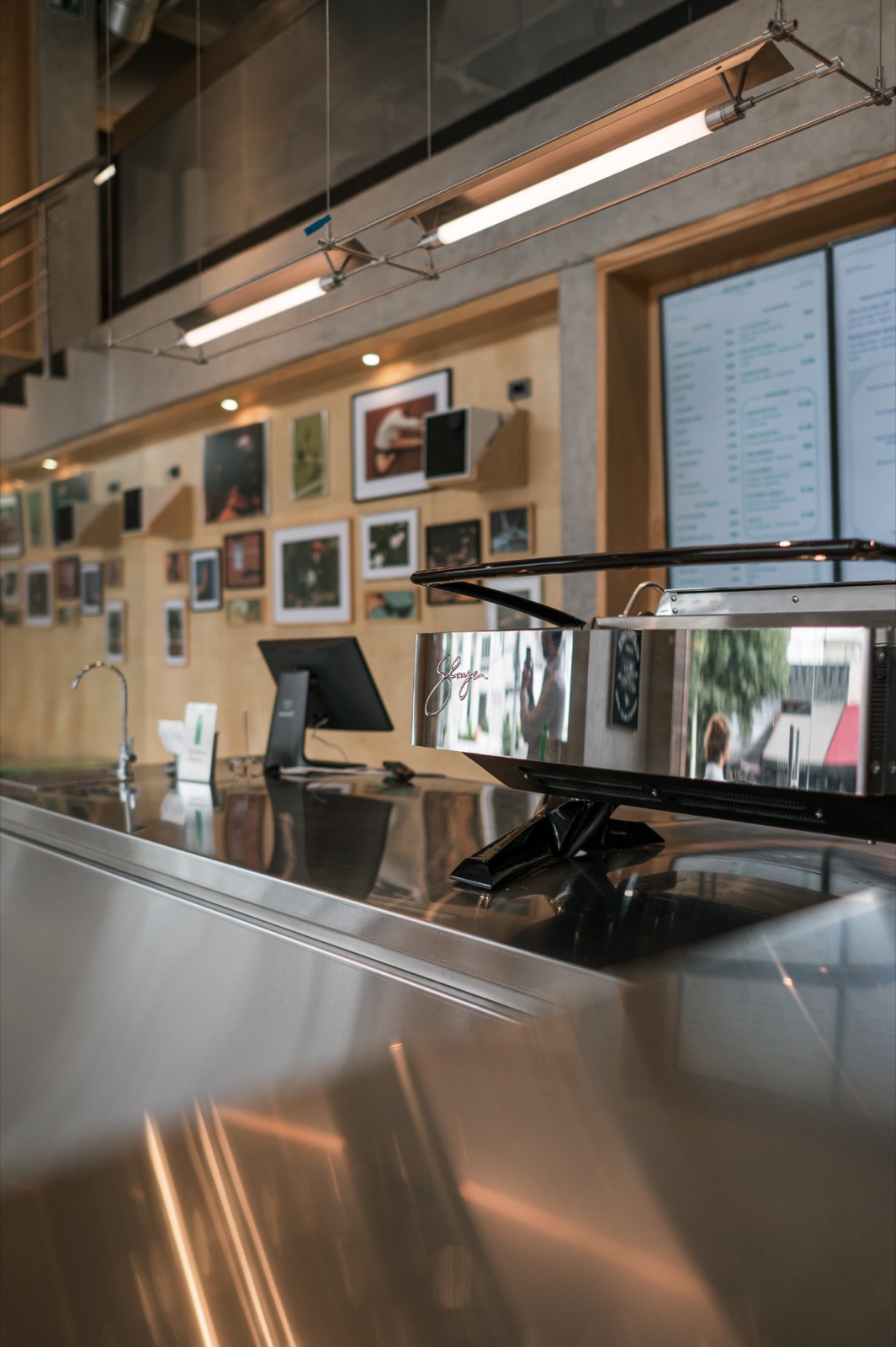 The espresso machine and the counter, with the photo wall behind