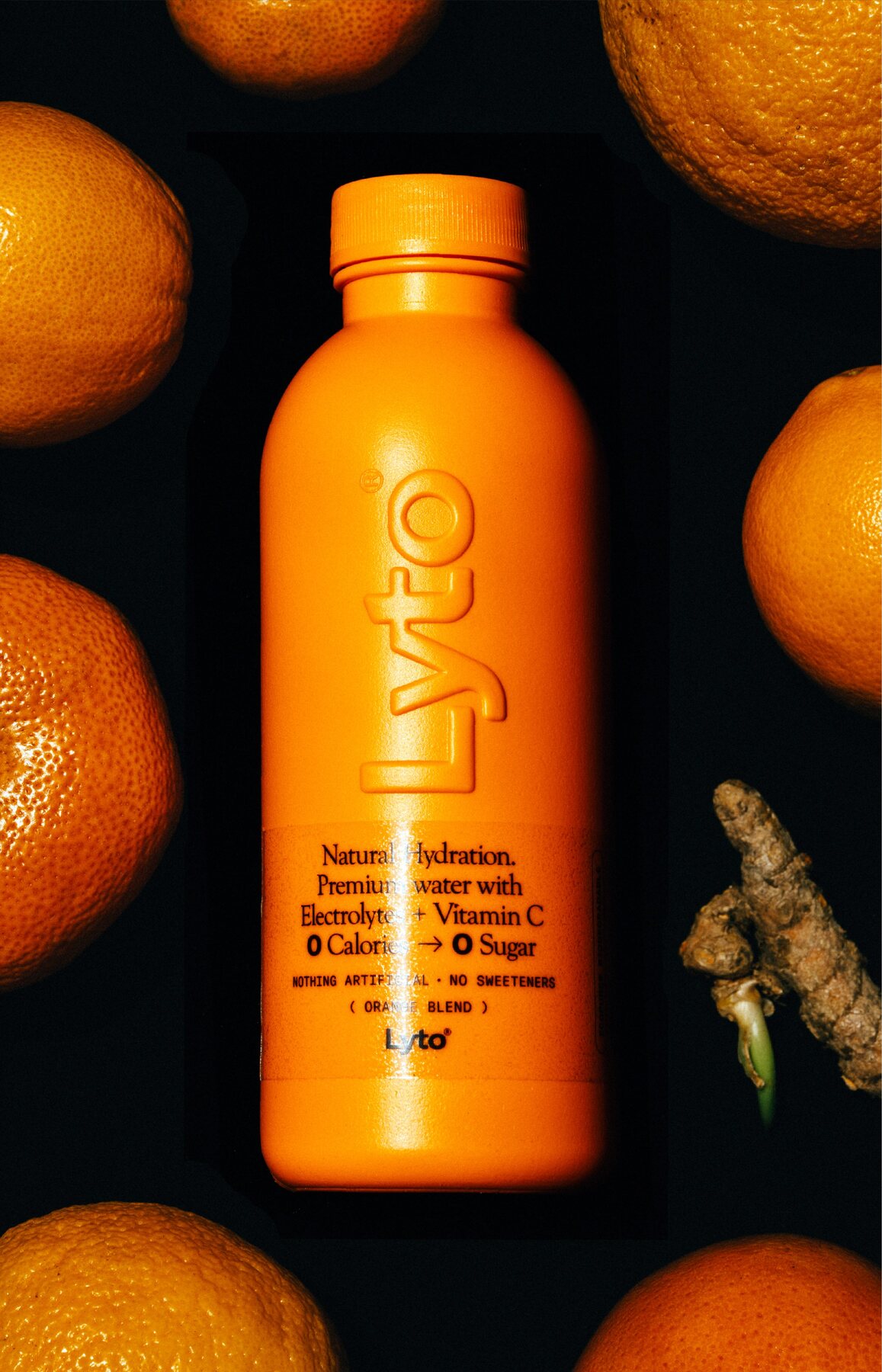Orange Blend bottle surrounded by oranges and ginger root