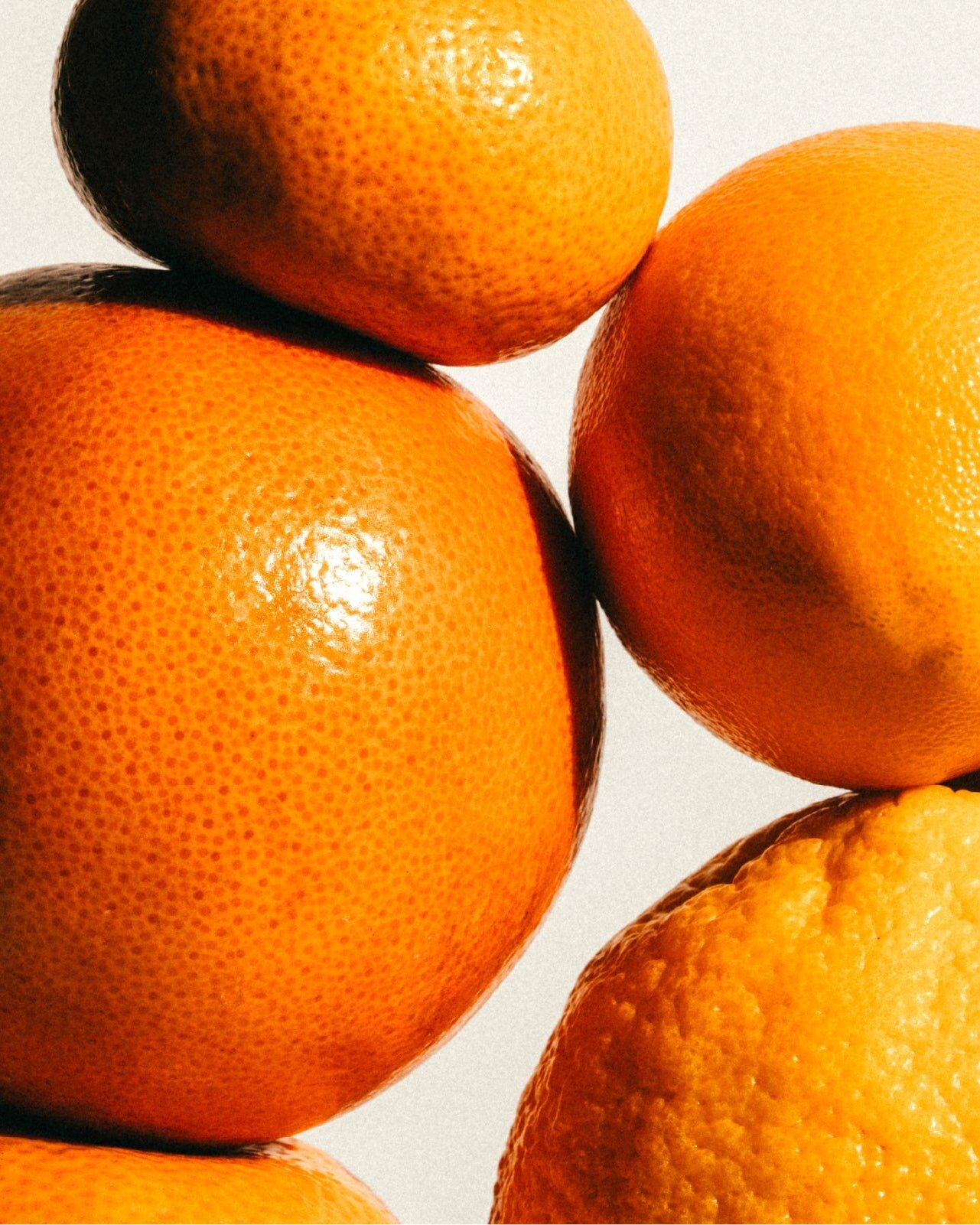 Stacked oranges on a light background
