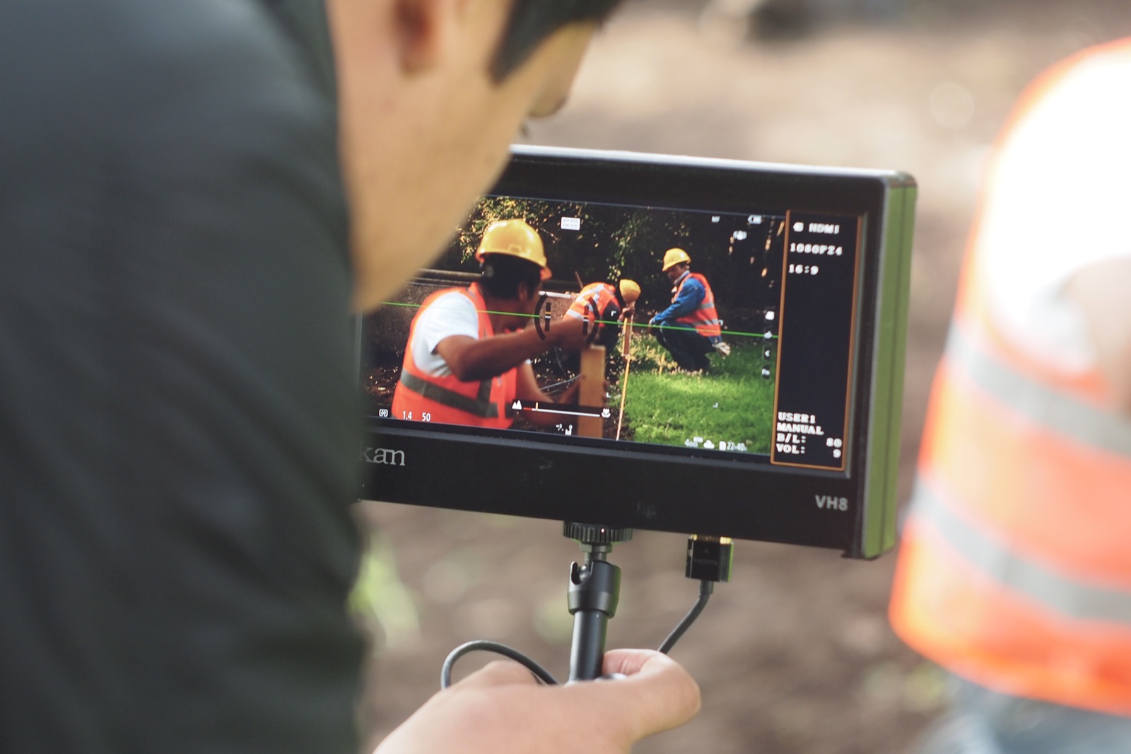 The crew on the camera monitor during a take